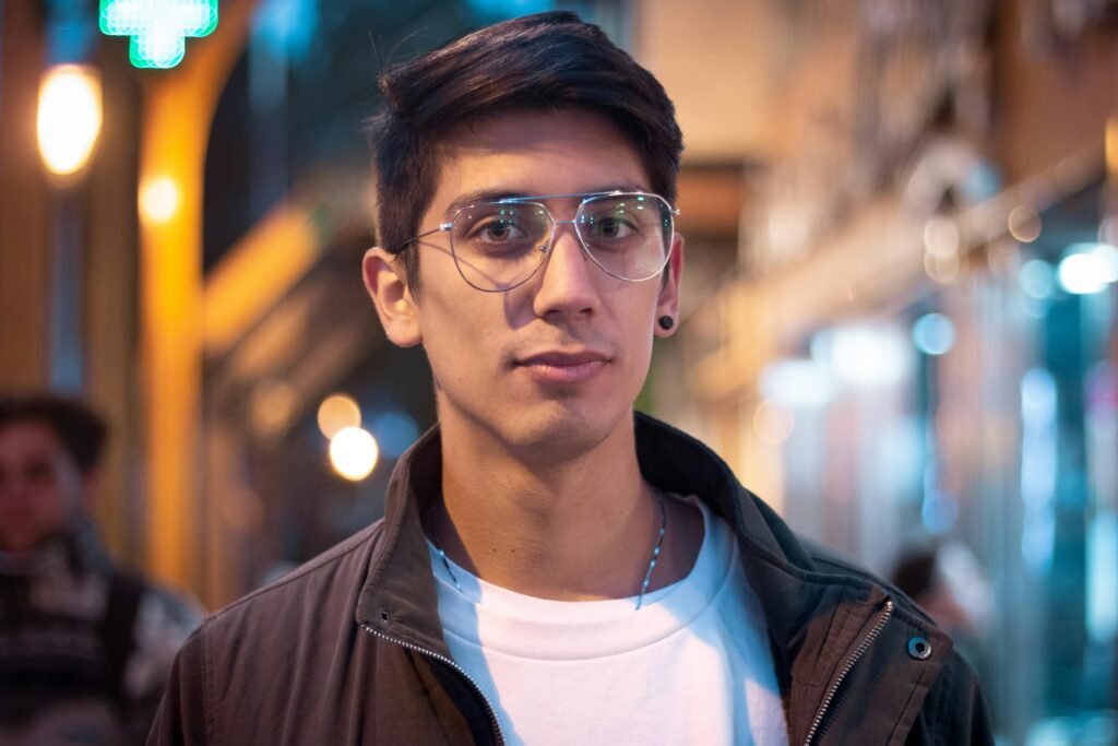 pexels-photo-13586632-13586632 Portrait of a young man wearing glasses in a vibrant night street of San Carlos de Bariloche, Argentina.